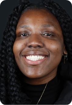 Woman in Queens smiling after orthodontic treatment